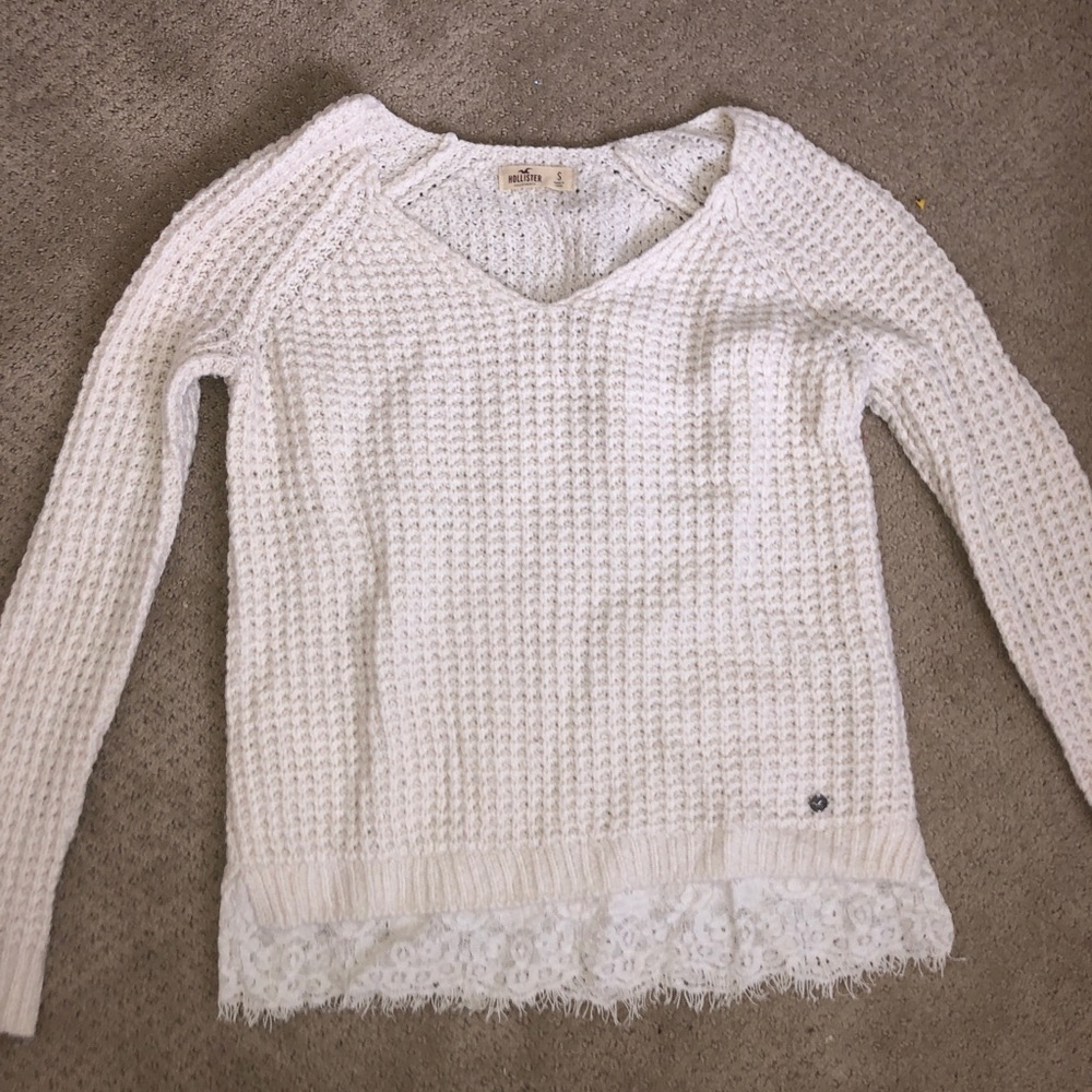White sweater with lacy detail at the bottom